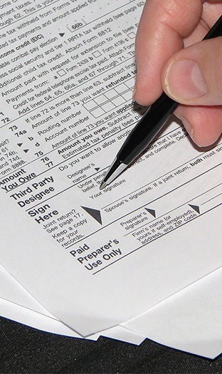 close up view of signing tax form